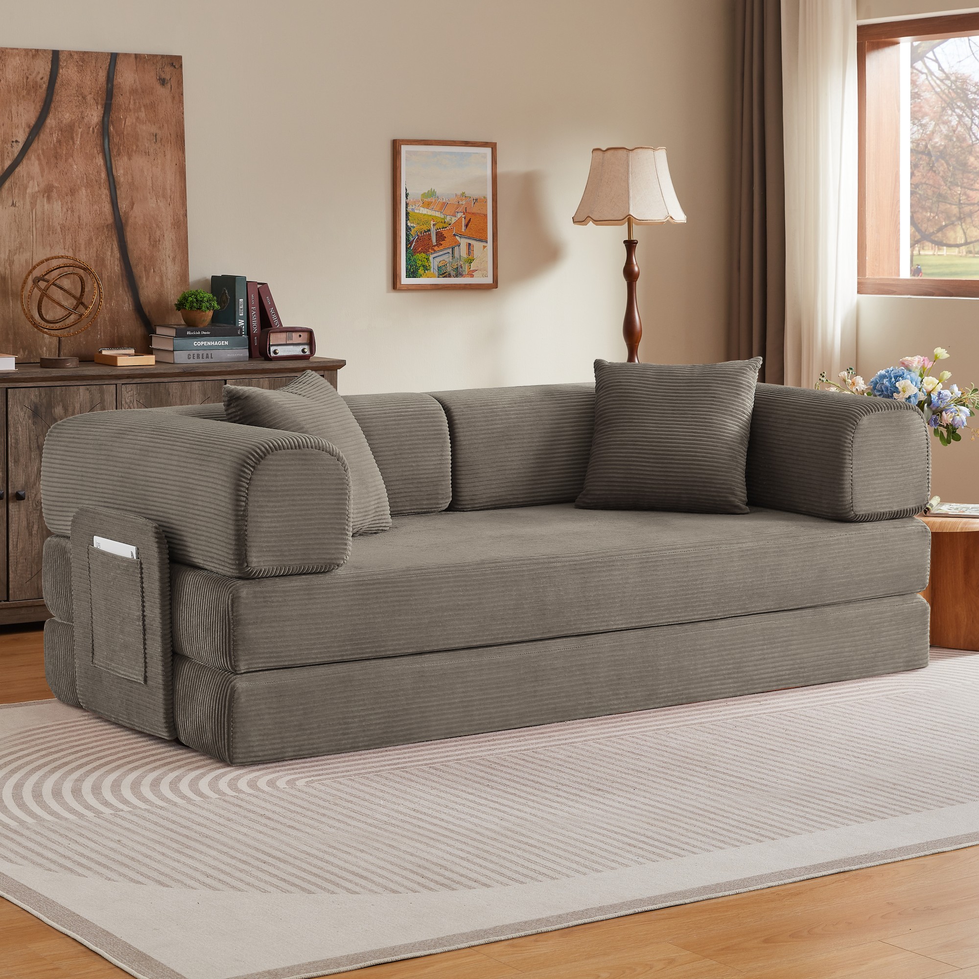 Canapé convertible taupe sur fond blanc